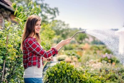 beautiful-young-woman-gardening-outside-in-summer-nature